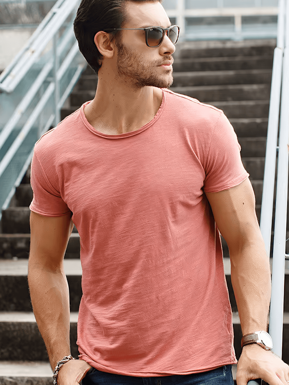 Man wearing elastic men's sport t-shirt with short sleeves, o-neck, in pink, perfect for casual outings or workouts. Model on stairs.